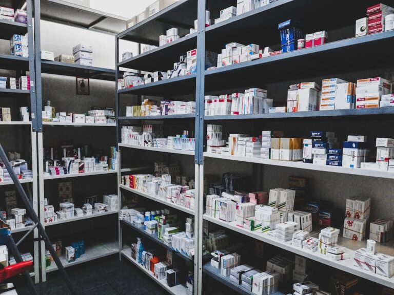 A hand places a prescription pill bottle in a closed, high dresser drawer near a digital thermometer.